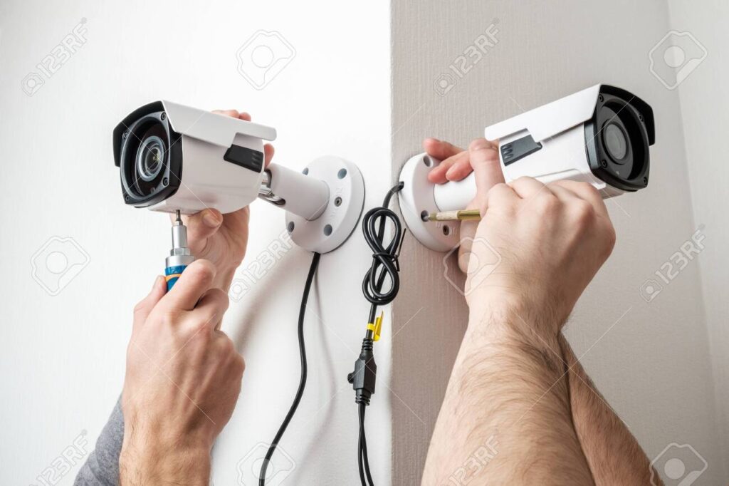 close up hands of technician adjusting cctv camera